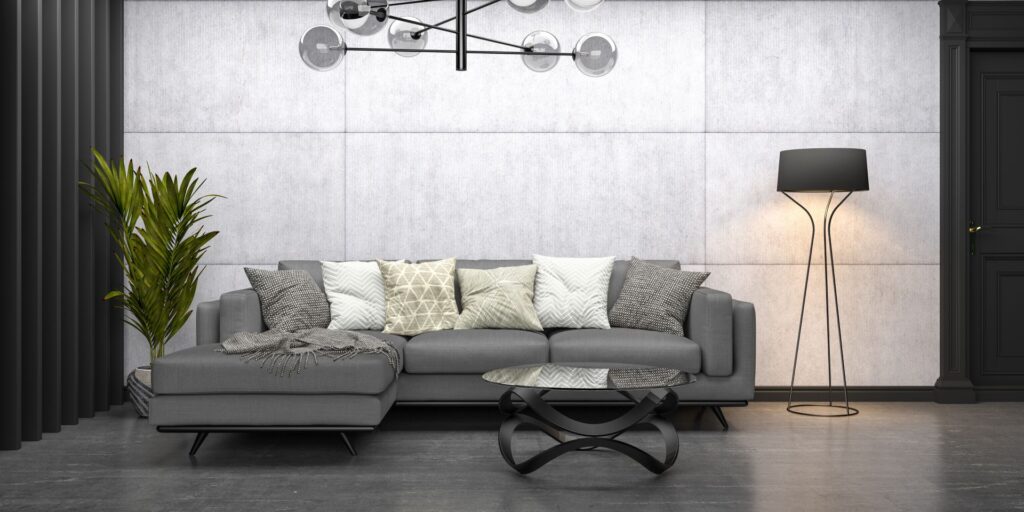 Modernes Wohnzimmer mit grauer couch, betonwand und schwarzen Designakzenten im minimalistischen Stil
